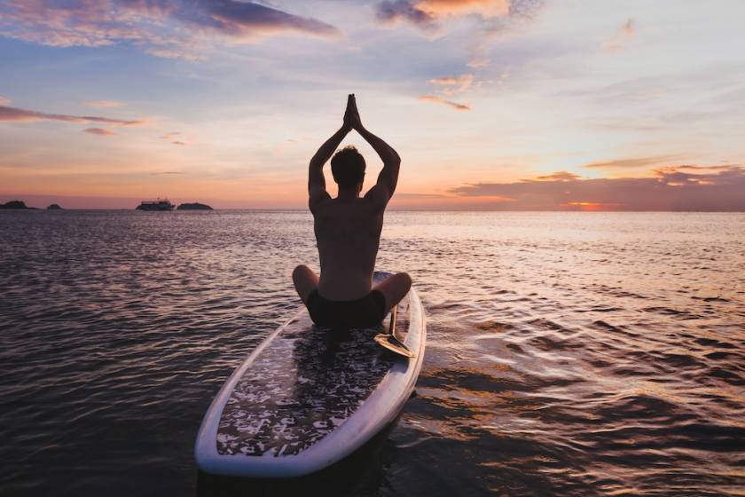 Man on Paddleboard doing yoga